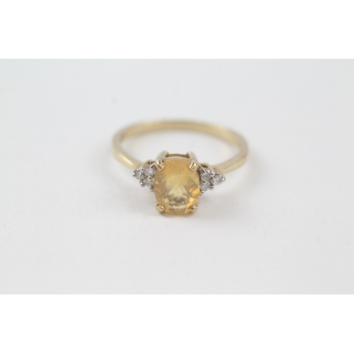 15 - 9ct gold yellow gemstone solitaire dress ring with diamond set shoulders (1.8g) Size  N 1/2