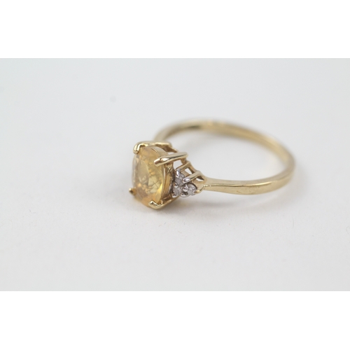 15 - 9ct gold yellow gemstone solitaire dress ring with diamond set shoulders (1.8g) Size  N 1/2