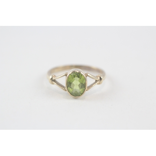 150 - 9ct gold oval cut peridot dress ring with split shoulders (2.1g) Size  N 1/2