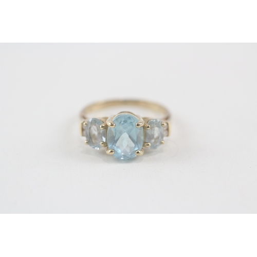 167 - 9ct gold oval cut blue topaz & diamond dress ring (2.8g) Size  M