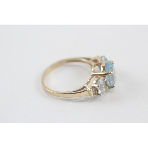 167 - 9ct gold oval cut blue topaz & diamond dress ring (2.8g) Size  M