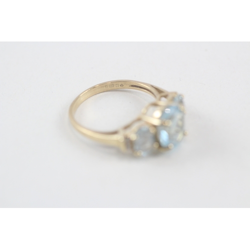 167 - 9ct gold oval cut blue topaz & diamond dress ring (2.8g) Size  M