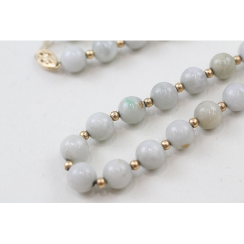 218 - 14ct gold clasped jade beaded necklace with 14ct gold spacer beads (42.3g)