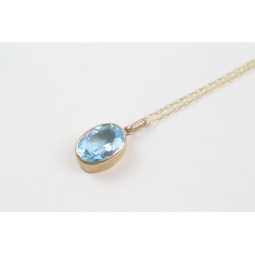 236 - 9ct gold oval cut blue topaz pendant necklace (2.9g)