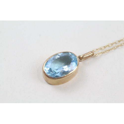 236 - 9ct gold oval cut blue topaz pendant necklace (2.9g)