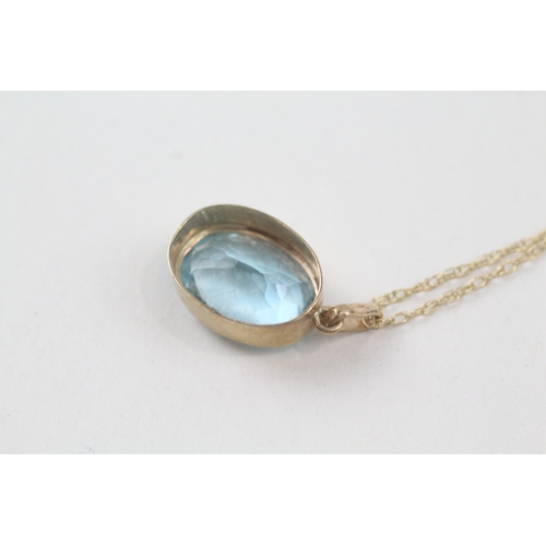 236 - 9ct gold oval cut blue topaz pendant necklace (2.9g)