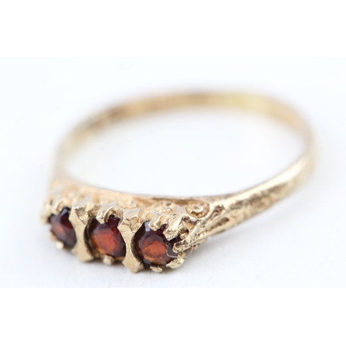 41 - 9ct gold vintage garnet three stone ring with scroll patterned gallery (1.9g) Size  N 1/2