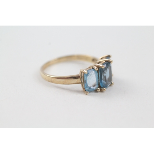 57 - 9ct gold blue topaz trilogy dress ring (2.9g) Size  P 1/2