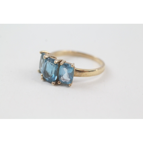 57 - 9ct gold blue topaz trilogy dress ring (2.9g) Size  P 1/2