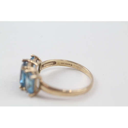 57 - 9ct gold blue topaz trilogy dress ring (2.9g) Size  P 1/2