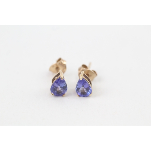 67 - 9ct gold trillion cut tanzanite stud earrings with scroll back earrings (1.1g)