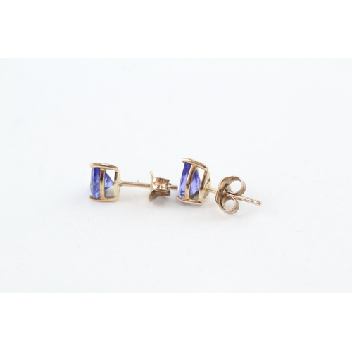 67 - 9ct gold trillion cut tanzanite stud earrings with scroll back earrings (1.1g)