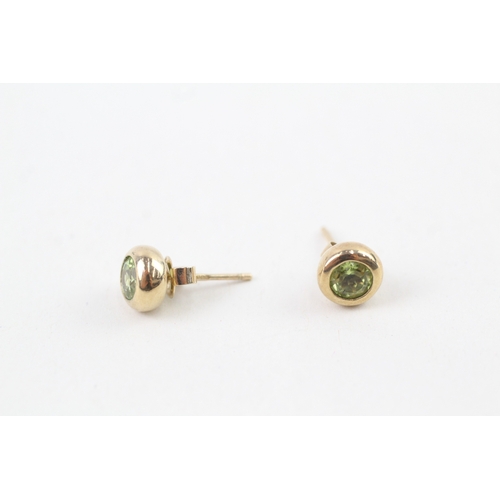 49 - 9ct gold peridot stud earrings with scroll backs (2.3g)