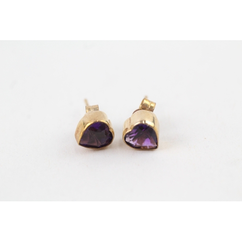 57 - 9ct gold amethyst heart shape stud earrings with scroll backs (1.2g)