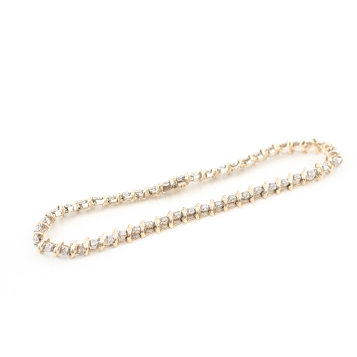 77 - 9ct gold diamond line bracelet (7.1g)