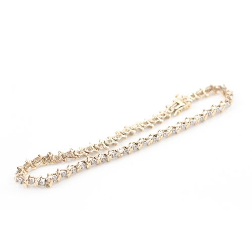 77 - 9ct gold diamond line bracelet (7.1g)