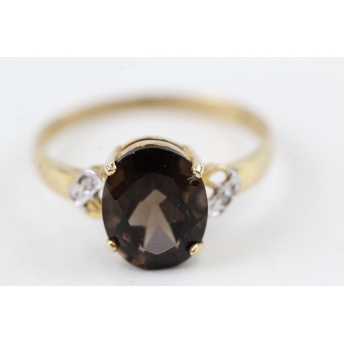 92 - 9ct gold oval cut smokey quartz & diamond dress ring (1.5g) Size  O