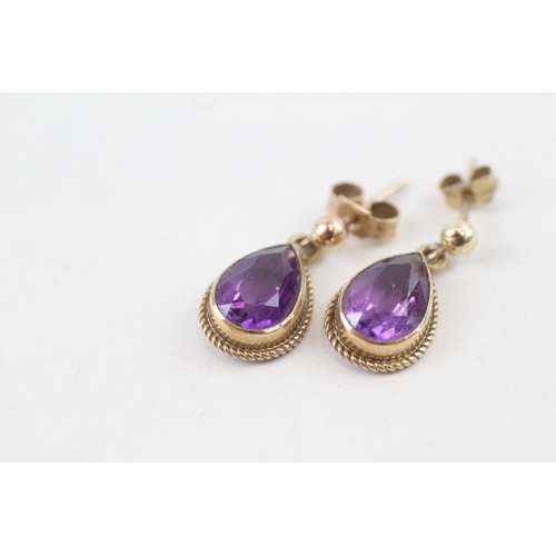 77 - 9ct gold pear cut amethyst drop earrings with scroll backs (2g)