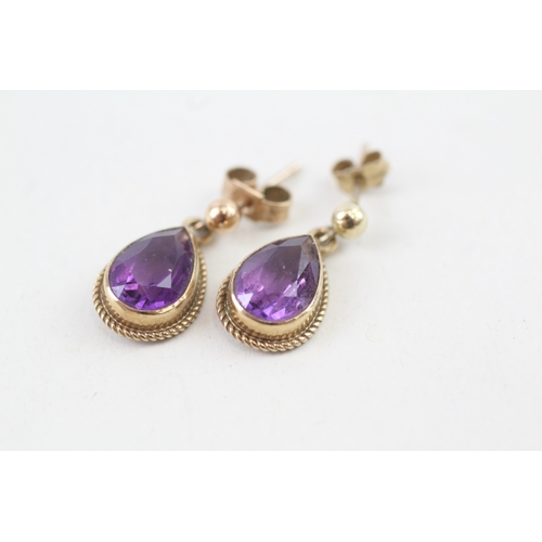 77 - 9ct gold pear cut amethyst drop earrings with scroll backs (2g)