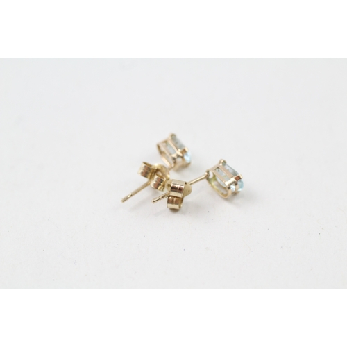 9 - 9ct gold oval cut blue topaz stud earrings (0.5g)