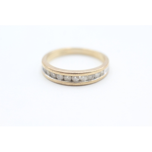 124 - 9ct gold channel set diamond eleven stone eternity ring (3.1g) Size  Q