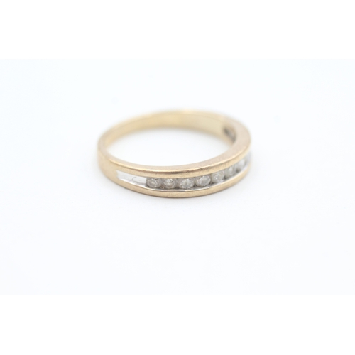 124 - 9ct gold channel set diamond eleven stone eternity ring (3.1g) Size  Q