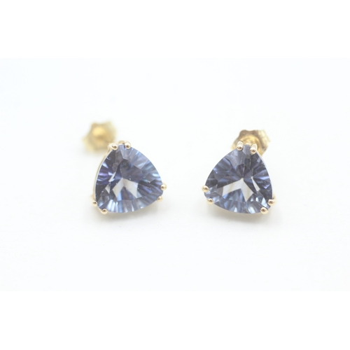 137 - 14ct gold trilliant cut blue topaz set stud earrings (2.5g)