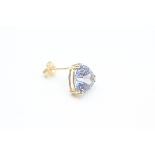 137 - 14ct gold trilliant cut blue topaz set stud earrings (2.5g)