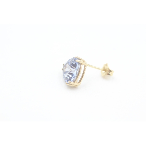 137 - 14ct gold trilliant cut blue topaz set stud earrings (2.5g)