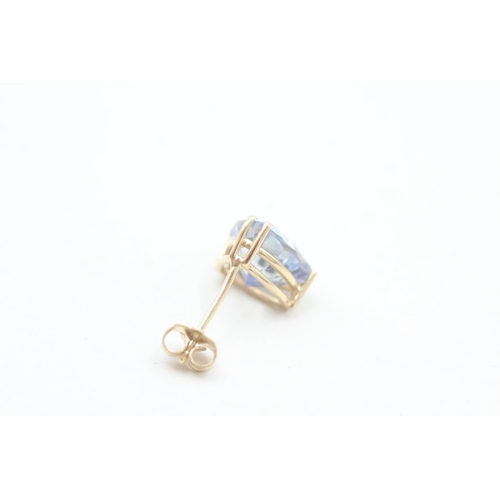 137 - 14ct gold trilliant cut blue topaz set stud earrings (2.5g)