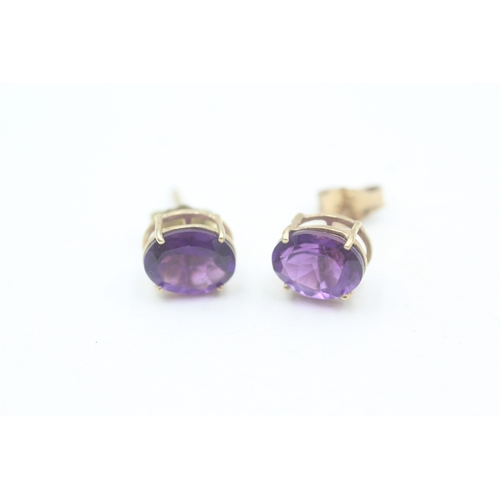 167 - 9ct gold oval cut amethyst set stud earrings (1.9g)