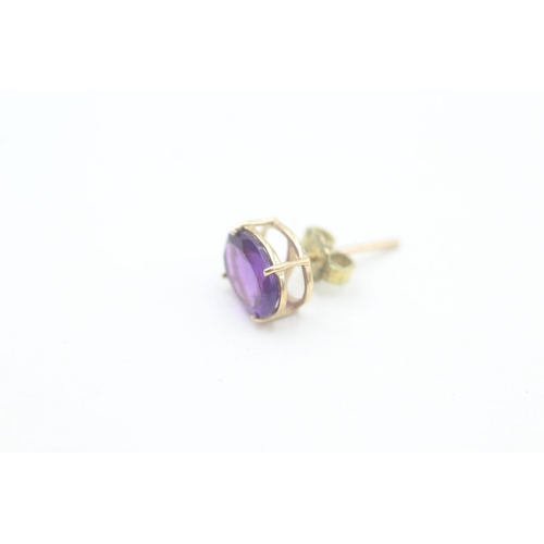 167 - 9ct gold oval cut amethyst set stud earrings (1.9g)