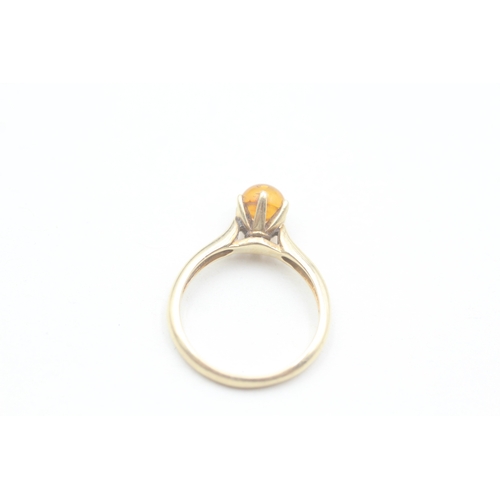 196 - 9ct gold claw set baltic amber cabochon solitaire ring (2.9g) Size  N