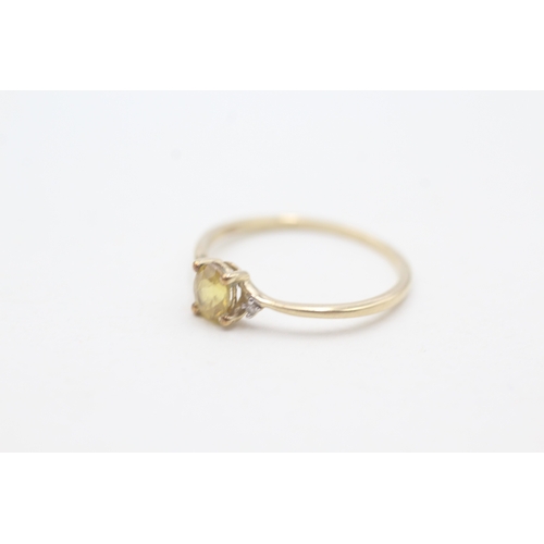 204 - 9ct gold delicate yellow gemstone and diamond set ring (0.8g) Size  M