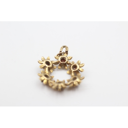 219 - 9ct gold garnet floral openwork pendant (1.9g)