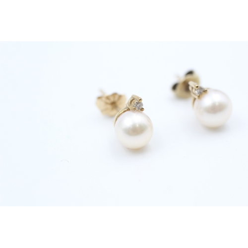 44 - 9ct gold diamond and cultured pearl set stud earrings (2g)