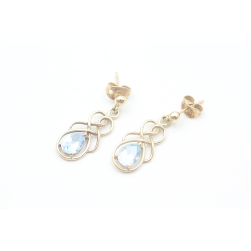 51 - 9ct gold pear cut blue topaz set celtic knot style drop earrings (2g)