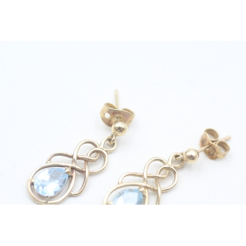 51 - 9ct gold pear cut blue topaz set celtic knot style drop earrings (2g)