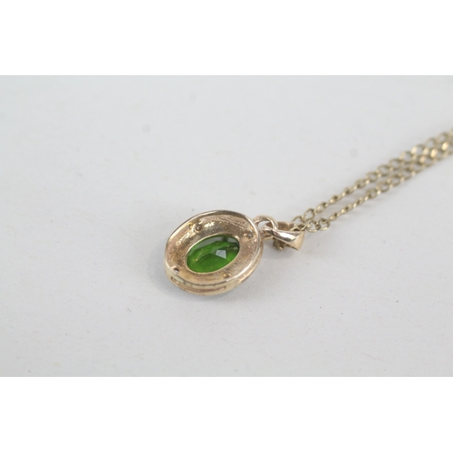 57 - 9ct gold diamond & diopside oval halo pendant necklace (2.1g)