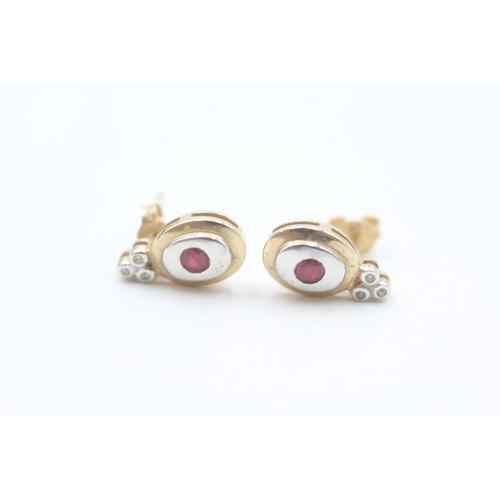 66 - 9ct white and yellow gold diamond and ruby set stud earrings (2g)