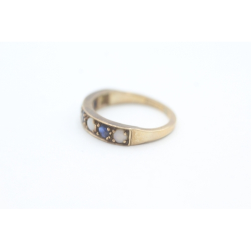 81 - 9ct gold opal and sapphire set seven stone eternity ring (2g) Size  K