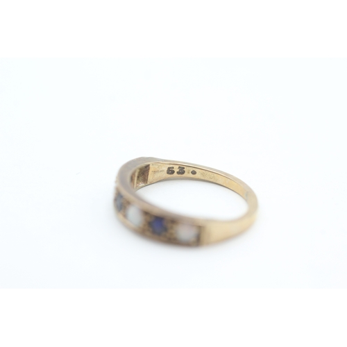 81 - 9ct gold opal and sapphire set seven stone eternity ring (2g) Size  K