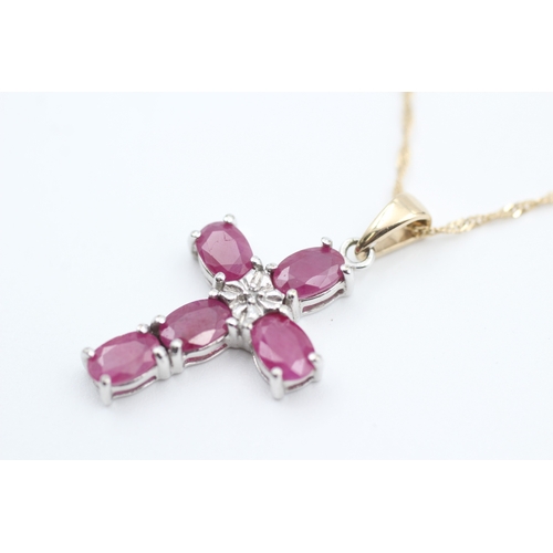 87 - 9ct gold diamond and ruby set cross pendant necklace (3.5g)