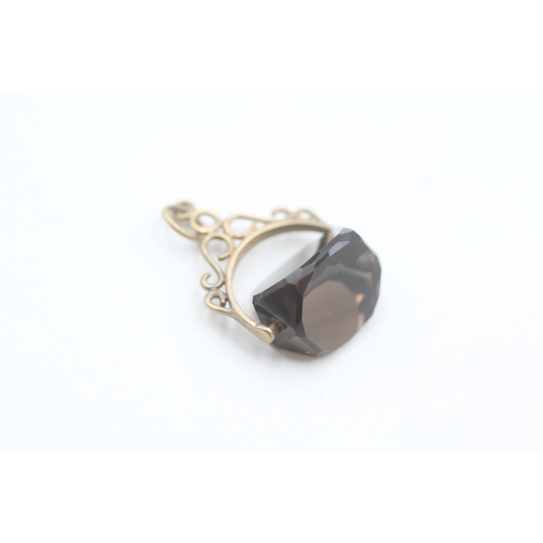 89 - 9ct gold smokey quartz spinner fob (1g)