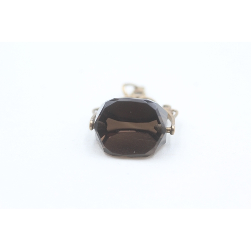 89 - 9ct gold smokey quartz spinner fob (1g)