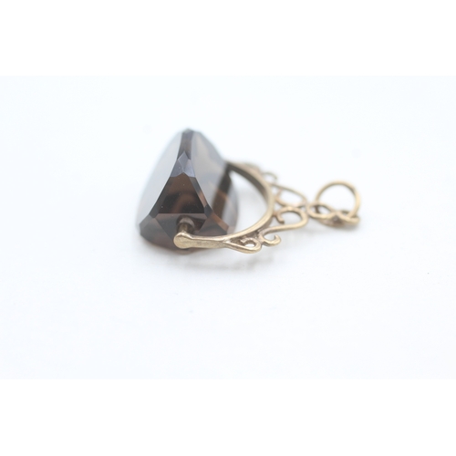 89 - 9ct gold smokey quartz spinner fob (1g)