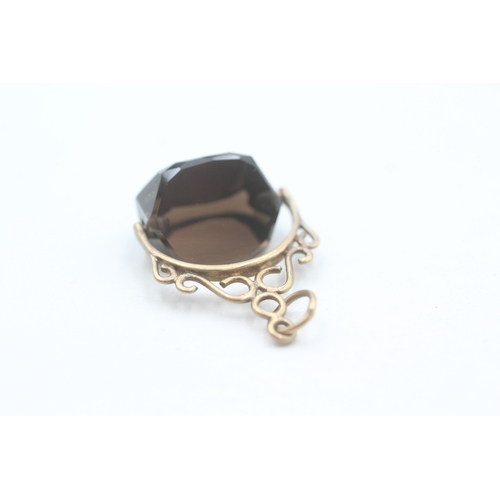 89 - 9ct gold smokey quartz spinner fob (1g)