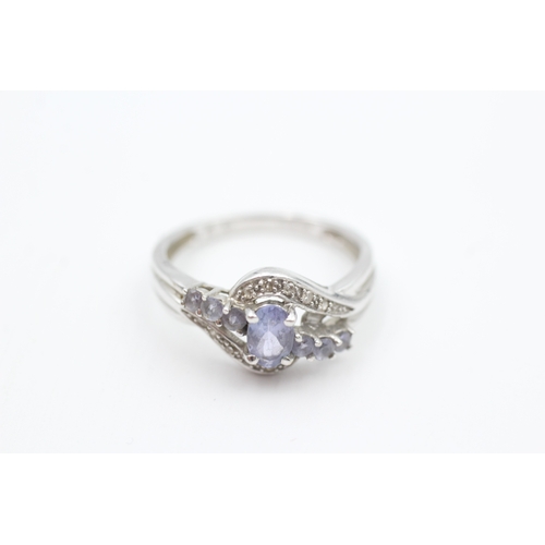 102 - 9ct white gold diamond accented tanzanite set dress ring (2.6g) Size  N