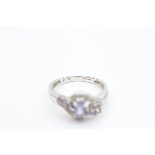 102 - 9ct white gold diamond accented tanzanite set dress ring (2.6g) Size  N