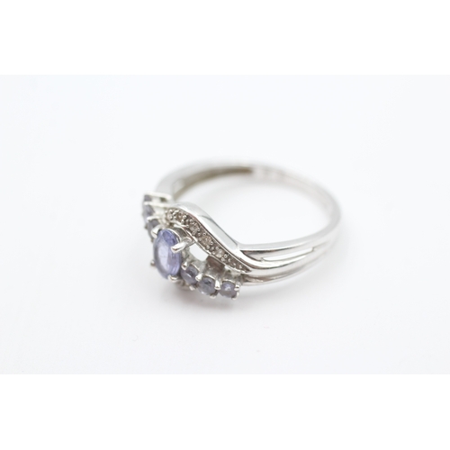 102 - 9ct white gold diamond accented tanzanite set dress ring (2.6g) Size  N